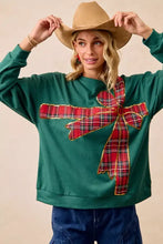 Green fleece pullover with a red and black plaid bow appliqué best fit for a christmas fleece pullover