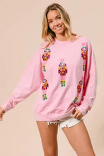Pink long-sleeved bibi sequin nutcrackers sweatshirt with colorful embroidered sequin nutcrackers design