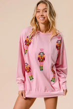 Pink long-sleeved bibi sequin nutcrackers sweatshirt with colorful sequined nutcracker designs on front and sleeves