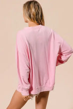 A soft pink oversized bibi sequin nutcrackers embroidery christmas sweatshirt with relaxed fit and frayed hem