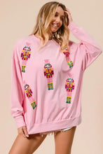 Pink oversized sweatshirt featuring bibi sequin nutcrackers embroidery in colorful sequins for christmas wear