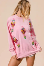 Pink bi bi sequin nutcrackers long-sleeved sweatshirt with deep green sequined nutcracker designs for christmas wear