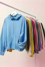 Light blue biBi fleece hoodie with elastic hem, half zip front, ribbed cuffs, and relaxed fit for casual wear
