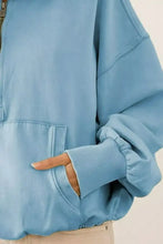 Light blue fleece hoodie with elastic hem, front zipper, ribbed cuffs, and relaxed fit made of soft cotton