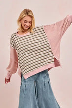 A soft oversized BiBi stripe sweater with patchwork beige and dark green torso, pink sleeves, cut edge, and reverse outseam
