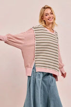 A soft pink and olive green striped oversized bibi stripe top with cut edge and reverse outseam ribbed cuffs