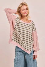A soft pink and olive green bibi stripe long-sleeve top with cut edge detail and reverse outseam in a relaxed fit