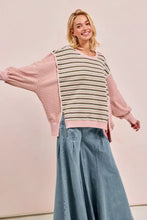 A soft pink and cream striped knit sweater with long puffed sleeves featuring cut edge and reverse outseam detailing