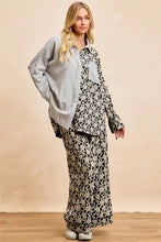 Black and white floral print wide-leg pants with relaxed silhouette complementing stripes jacquard floral mix top
