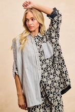 A woman wears a BiBi stripes jacquard floral mix and match shirt top with black and white floral and gray striped sides
