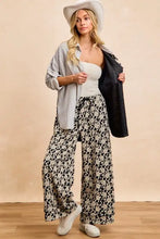 A woman wearing a white cowboy hat models a BiBi stripes jacquard floral mix and match shirt top