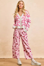 Pink heart-patterned wide-leg pants with textured heart buttoned cardigan