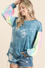 A soft oversized blue tie dye french terry top with rainbow sleeves and relaxed fit from bibi collection