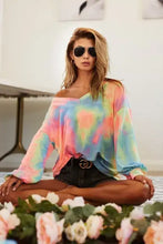 A vibrant slightly oversized tie dye french terry off-the-shoulder top in pastel pink blue and yellow from BiBi