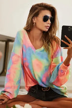 BiBi tie dye french terry v neck top with pink blue green yellow swirling patterns and ruffled cuffs for music festivals