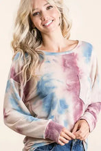 A slightly stretchy bibi tie dye print terry top with patch pocket in pastel blue and pink hues with a relaxed fit