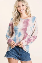 A soft bibi tie dye terry top in pastel blue and pink with a relaxed fit, slightly stretchy fabric, and front patch pocket
