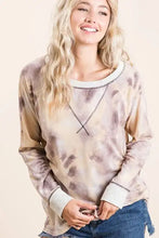 A soft bibi tie dye terry pullover with muted beige and brown tones featuring contrast stitching and white trim