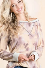 A bibi tie dye terry pull over featuring a soft off-the-shoulder design with contrast stitching in beige and dusty purple