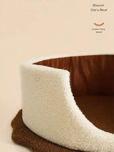 Biscuit style pet nest with cream plush exterior and brown interior