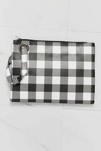Black and white buffalo plaid printed wristlet clutch bag with zip and strap