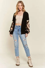 Black and snake print crochet cardigan with distressed jeans and lace-up boots by Free People