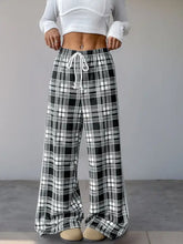 Black and white plaid wide-leg drawstring shorts with pattern