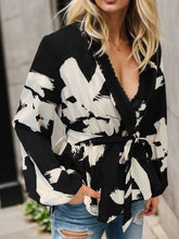 Black and White Wrap Blouse with Belted Waist and Medium Sleeve Length
