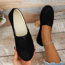 Black round toe flats with suede upper and silver ankle bracelet