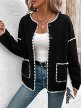 Black cardigan with white trim and geometric stitch detail, machine washable