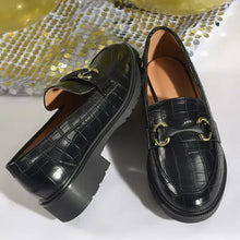 Round toe block heels loafers in black crocodile-embossed with gold horsebit buckles