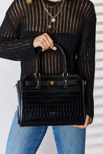Black crocodile-embossed leather handbag with gold-tone hardware