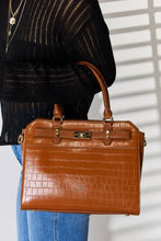 Tan crocodile embossed leather handbag with gold hardware