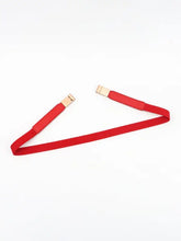 Black elastic skinny belt with gold buckle and red elastic cord accents