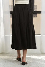 Black tiered midi skirt with flattering elastic waistband and flowing tiers
