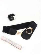 Black elastic wide belt with gold buckle, ring closure, and textured weave