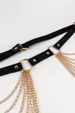 Black faux leather belt with gold chains, buckle, and tassels
