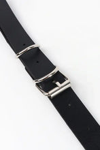Black faux leather belt with gold chains, silver buckle, and double loop design
