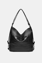 Black glossy faux leather shoulder bag with front zipper pocket and straps