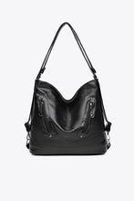 Black faux leather shoulder bag with zippered pockets and silver hardware