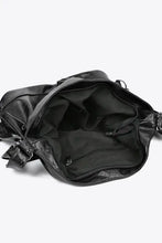 Black faux leather shoulder bag with convertible backpack straps and zipper pockets