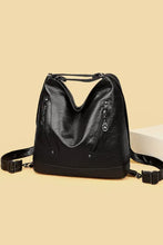 Sleek black PU leather shoulder bag with zipper pockets and metallic accents