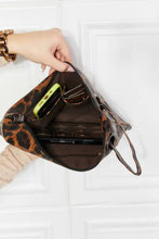 Black faux leather wristlet clutch bag with leopard print tote accents