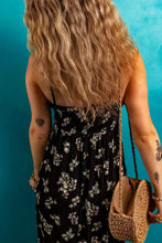 Black floral spaghetti strap empire waist maxi dress with straw bag