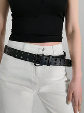 Black grommet PU leather belt with double buckle on white pants
