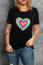 Woman in black heart round neck short sleeve t shirt and blue jeans