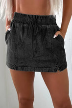 Black high waist mini skirt with drawstring, elastic waistband, and pockets