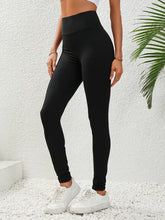 Black high waisted opaque leggings with sleek stretchy texture