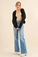 Black knitting bolero cardigan with cable-knit design, wide-leg jeans, beige crop top
