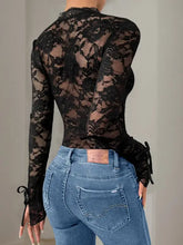 Black lace long sleeve bodysuit in highly stretchy material with blue jeans